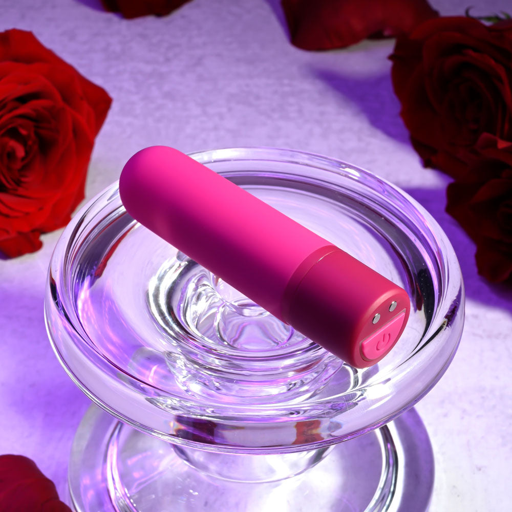Selopa TINY TEMPTATION -  9.2 cm USB Rechargeable Bullet placed in a glass dish surrounded by red roses.
