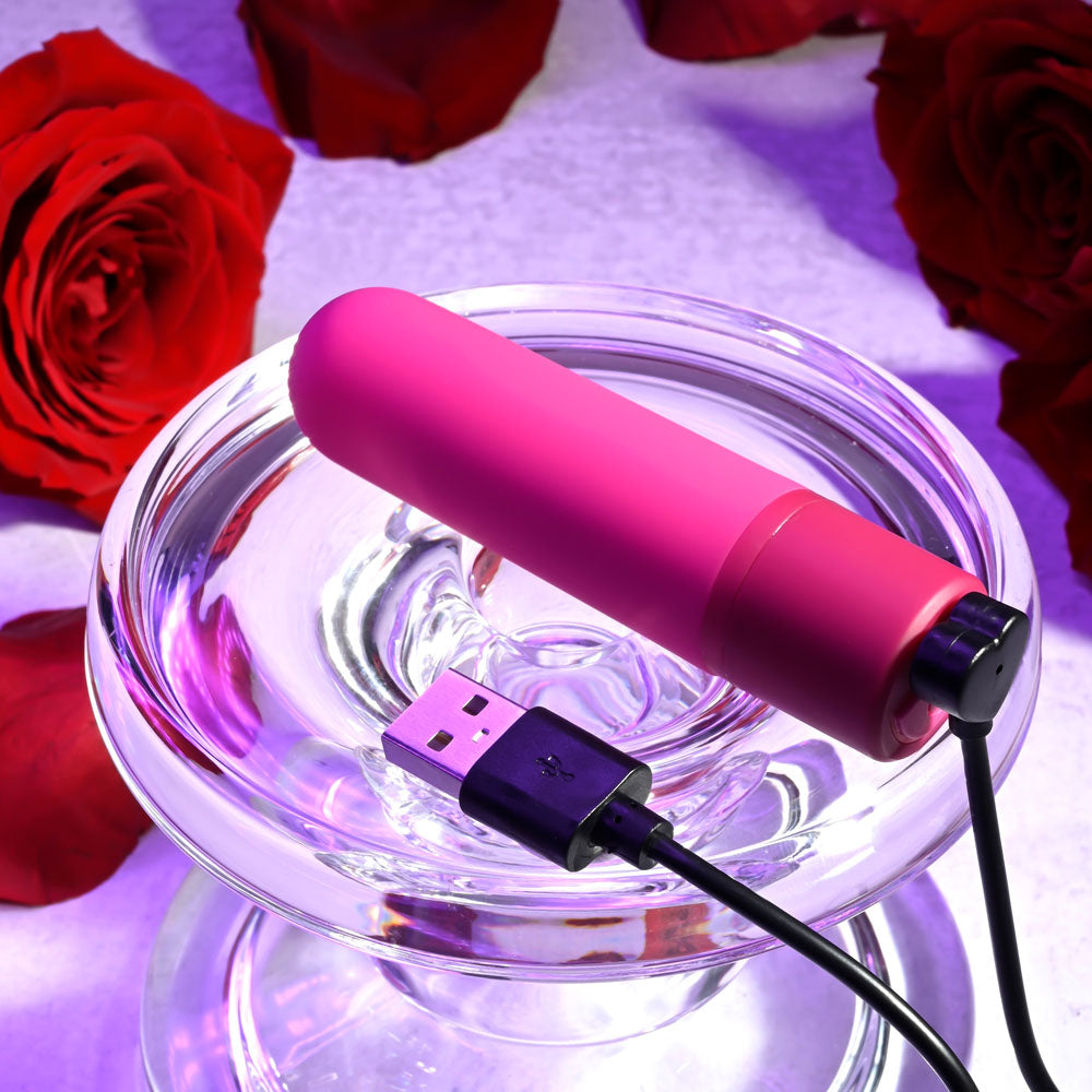 Selopa TINY TEMPTATION -  9.2 cm USB Rechargeable Bullet resting on a glass dish surrounded by red roses, highlighting its features.