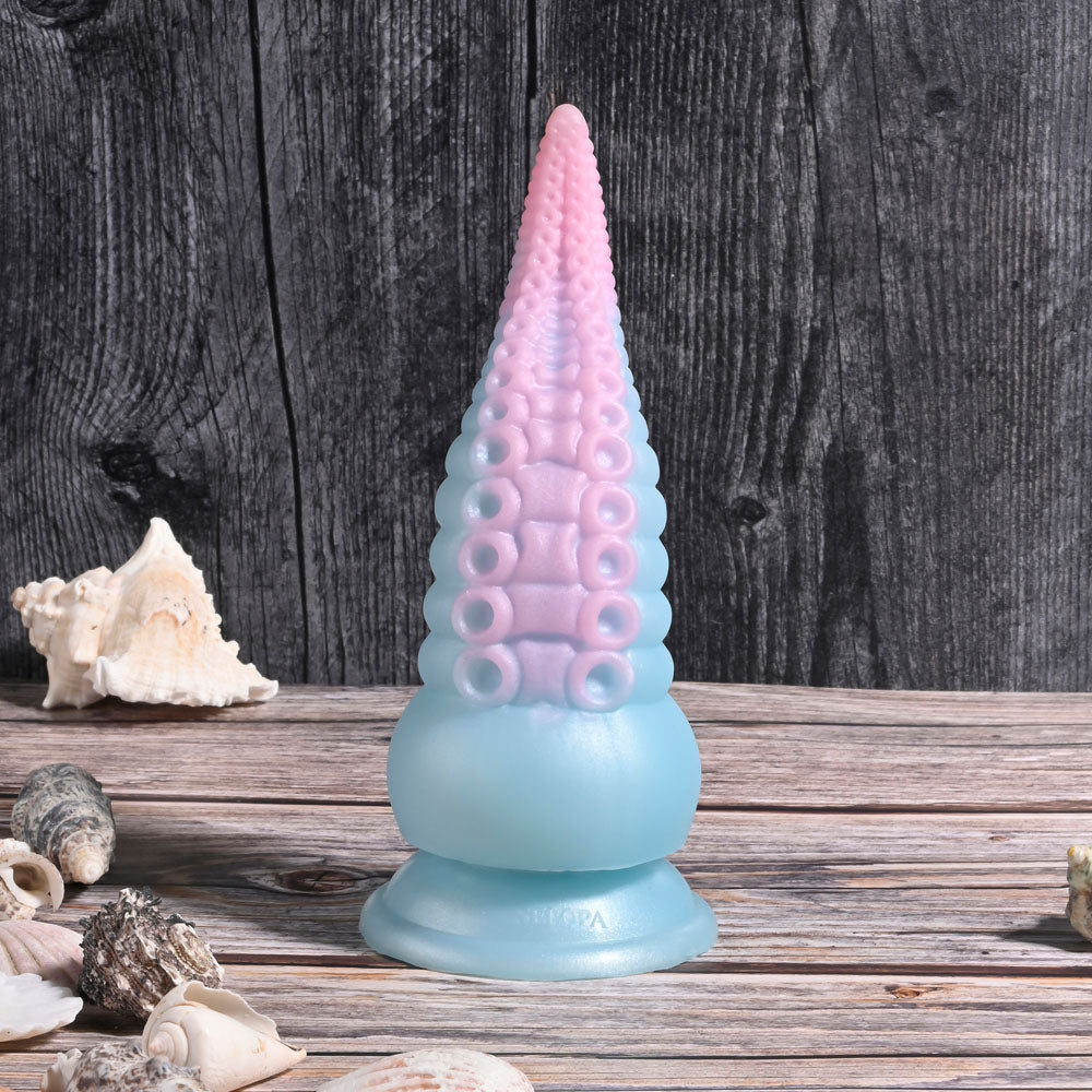 Selopa STUCK ON YOU - Blue/Pink 19 cm USB Rechargeable Vibrating Tentacle Fantasy Dildo on a wooden surface with seashells.