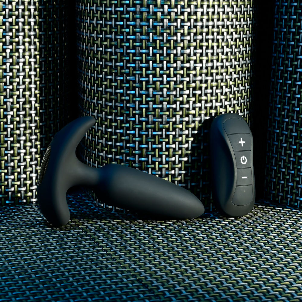 Selopa  BEAUTY -  11.3 cm USB Rechargeable Vibrating Butt Plug with Wireless Remote on a textured surface.