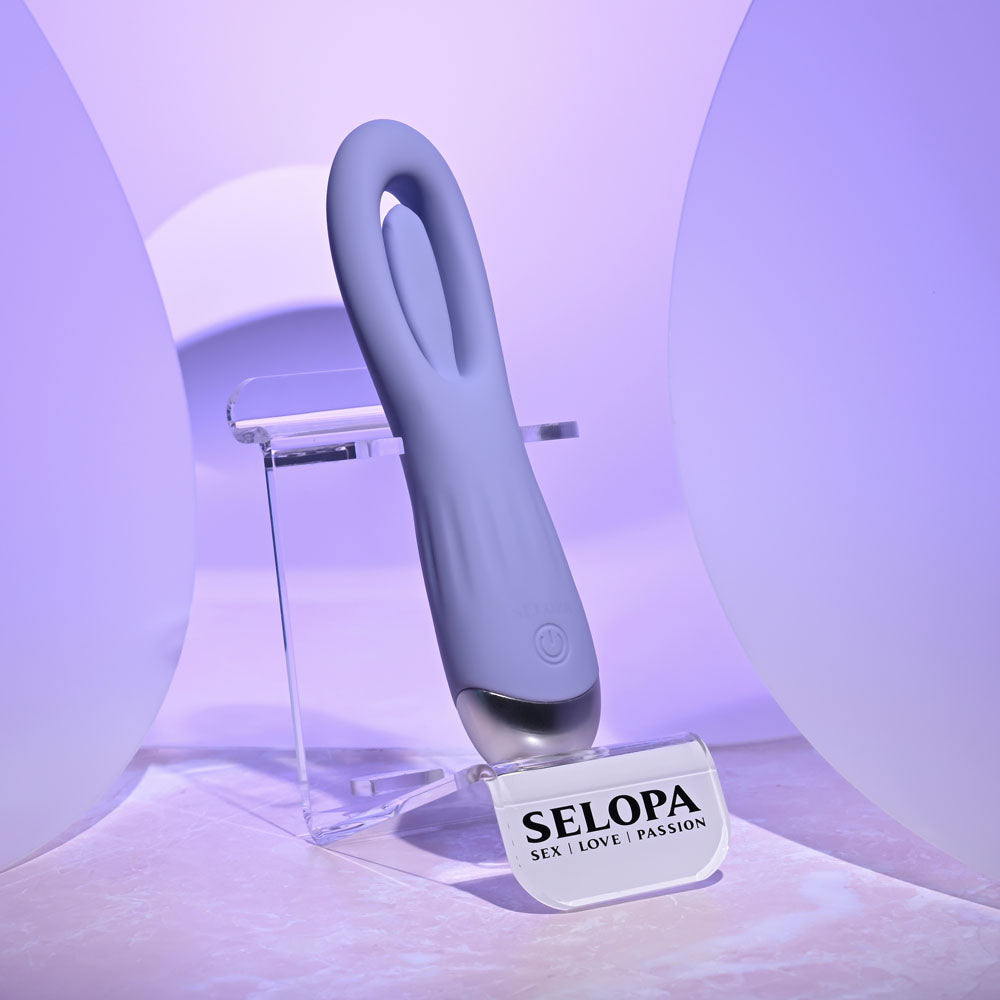 Selopa IN A FLAP - 15 cm USB Rechargeable Flicking Stimulator displayed on a stand, showcasing its sleek design.