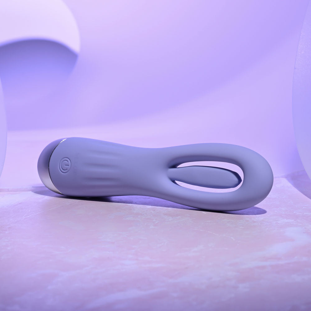 Selopa IN A FLAP -  15 cm USB Rechargeable Flicking Stimulator on a smooth surface with soft lighting.