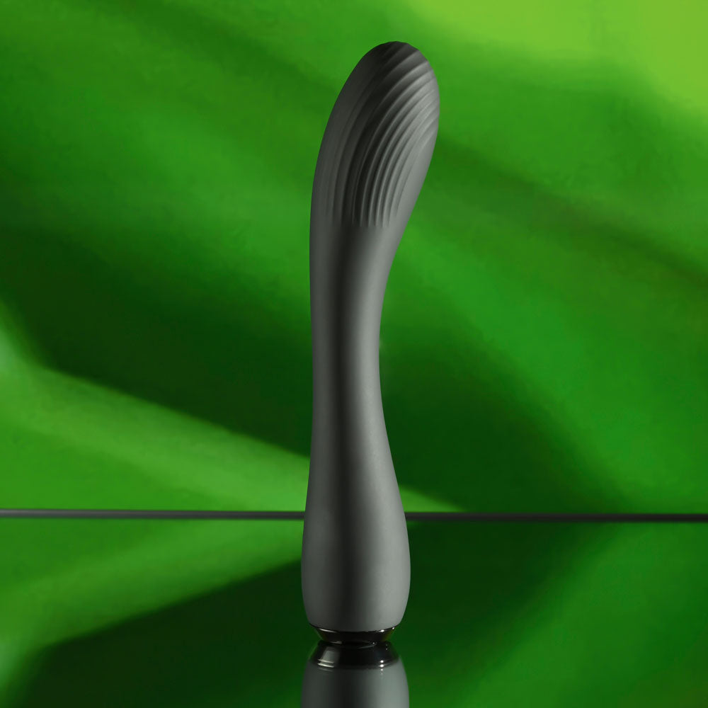 Selopa MIDNIGHT MAGIC -  20.2 cm USB Rechargeable Vibrator on a reflective surface with a green background.