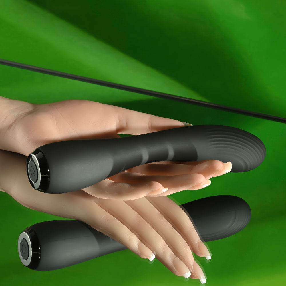 Selopa MIDNIGHT MAGIC -  20.2 cm USB Rechargeable Vibrator in a hand against a green background.