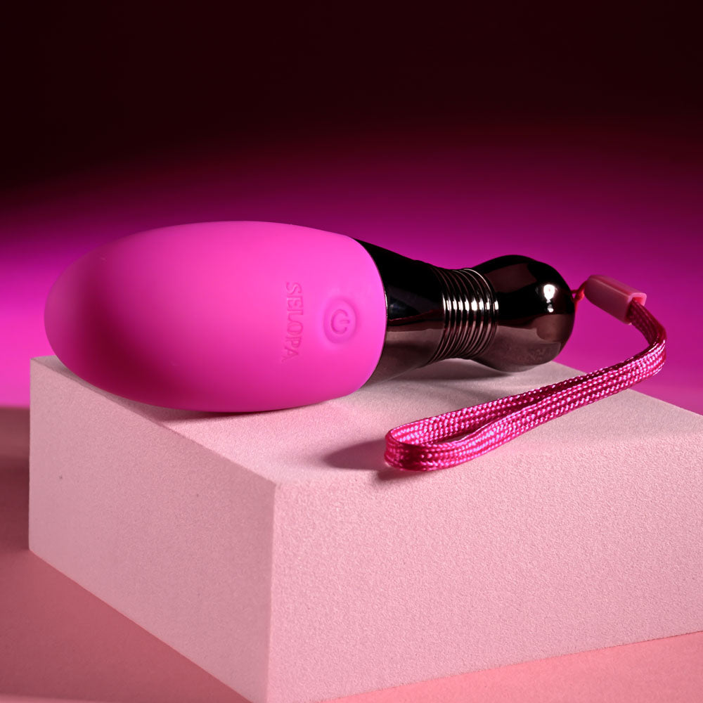 Selopa COMPANION -  11.9 cm USB Rechargeable Vibrating Egg on display with pink accents and safety retrieval cord.