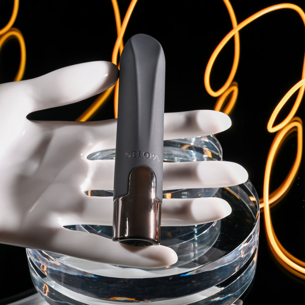 Selopa LITTLE BUDDY - 11.1 cm USB Rechargeable Vibrating Bullet held in a hand with a sleek design and chrome base.
