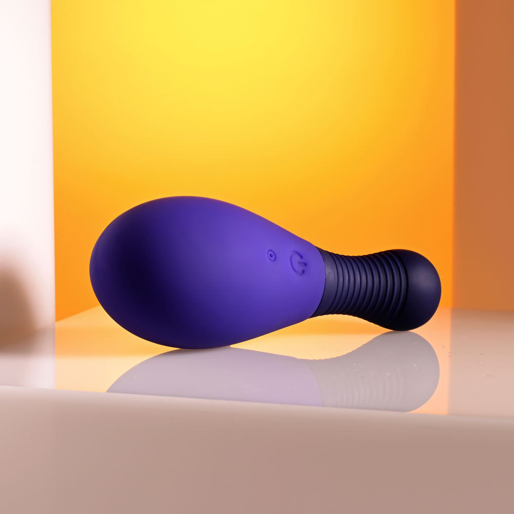 Selopa EGG ME ON -  10 cm USB Rechargeable Egg with Wireless Remote on a smooth surface.