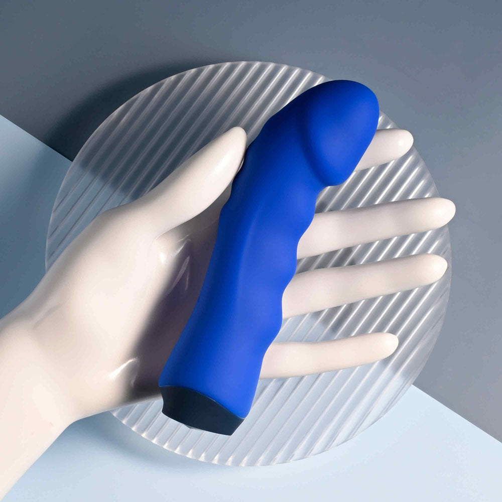 Selopa BANGER - 13.6 cm USB Rechargeable Vibrator held in a hand on a textured plate.