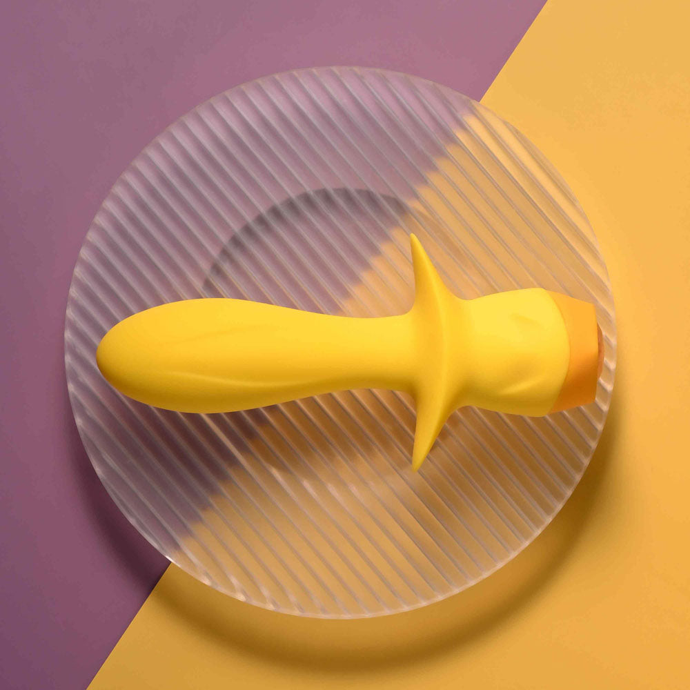 Selopa MELLOW - 13.5 cm USB Rechargeable Vibrating Anal Plug on a textured round plate, vibrant yellow color.