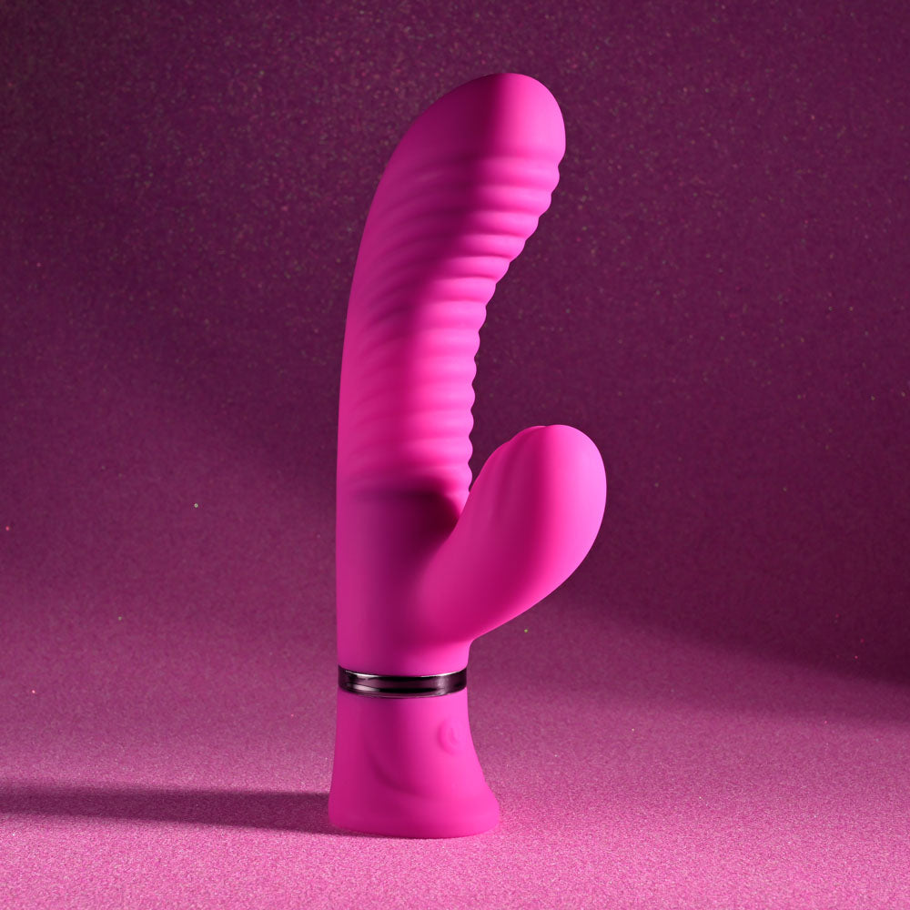 Selopa NEXT WAVE - 16.4 cm USB Rechargeable Dual Vibrator on a shimmering pink background.