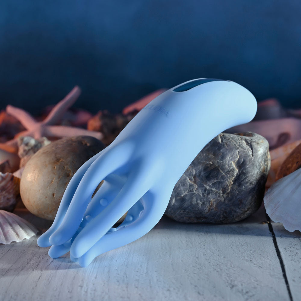 Selopa TENTACLE TICKLER - USB Rechargeable Vibrating Stimulator, blue silicone vibrating toy on textured background.