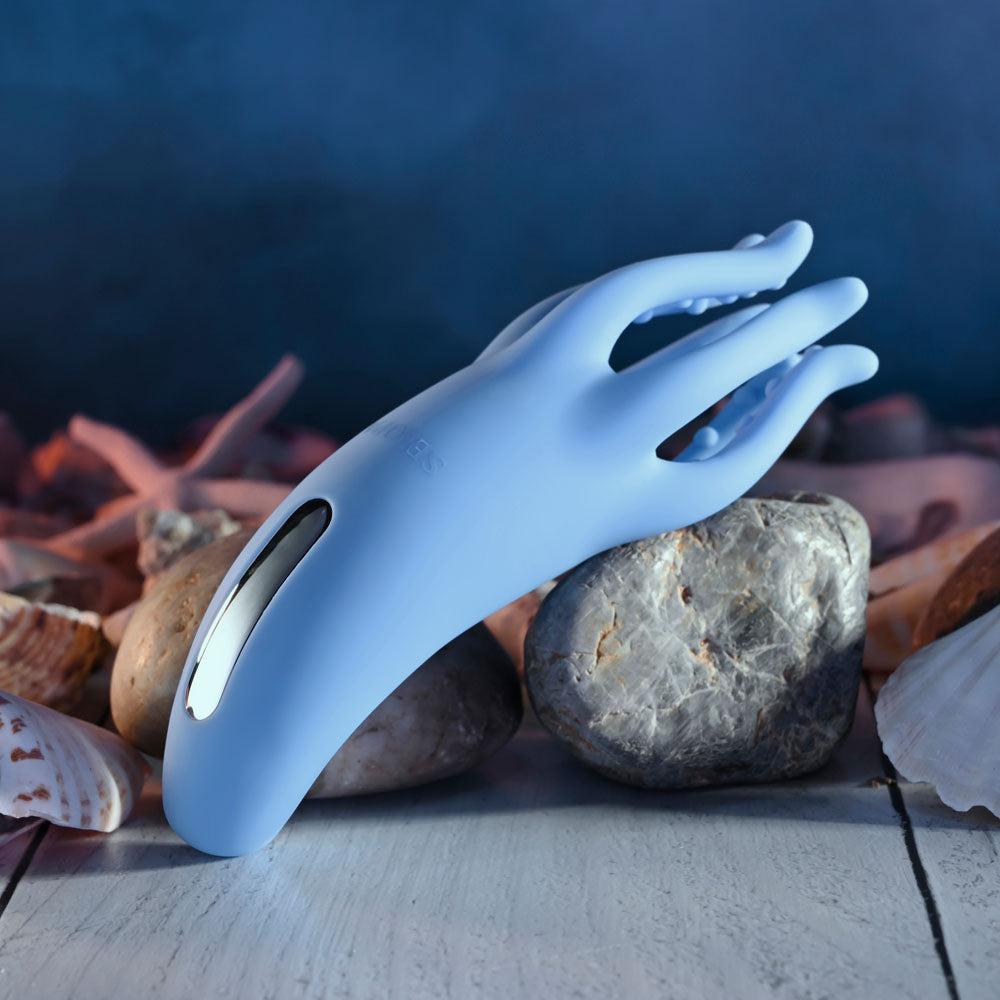 Selopa TENTACLE TICKLER -  USB Rechargeable Vibrating Stimulator on a bed of seashells and stones.