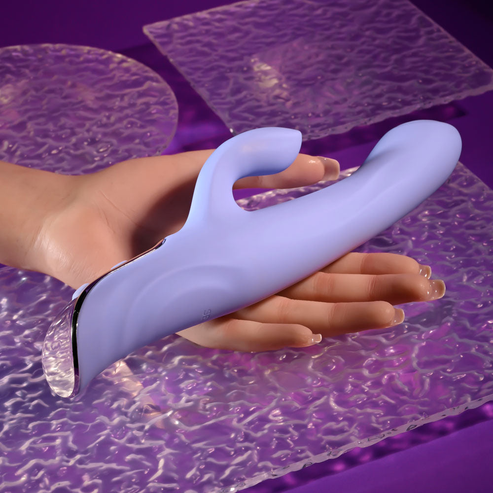 Evolved LAVENDER LOVE - 23.3 cm USB Rechargeable Rabbit Vibrator held in hand on a textured surface.