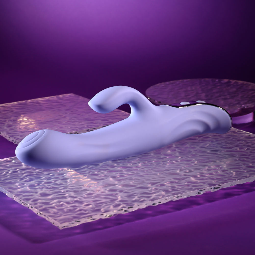 Evolved LAVENDER LOVE - 23.3 cm USB Rechargeable Rabbit Vibrator on textured surfaces in purple lighting.