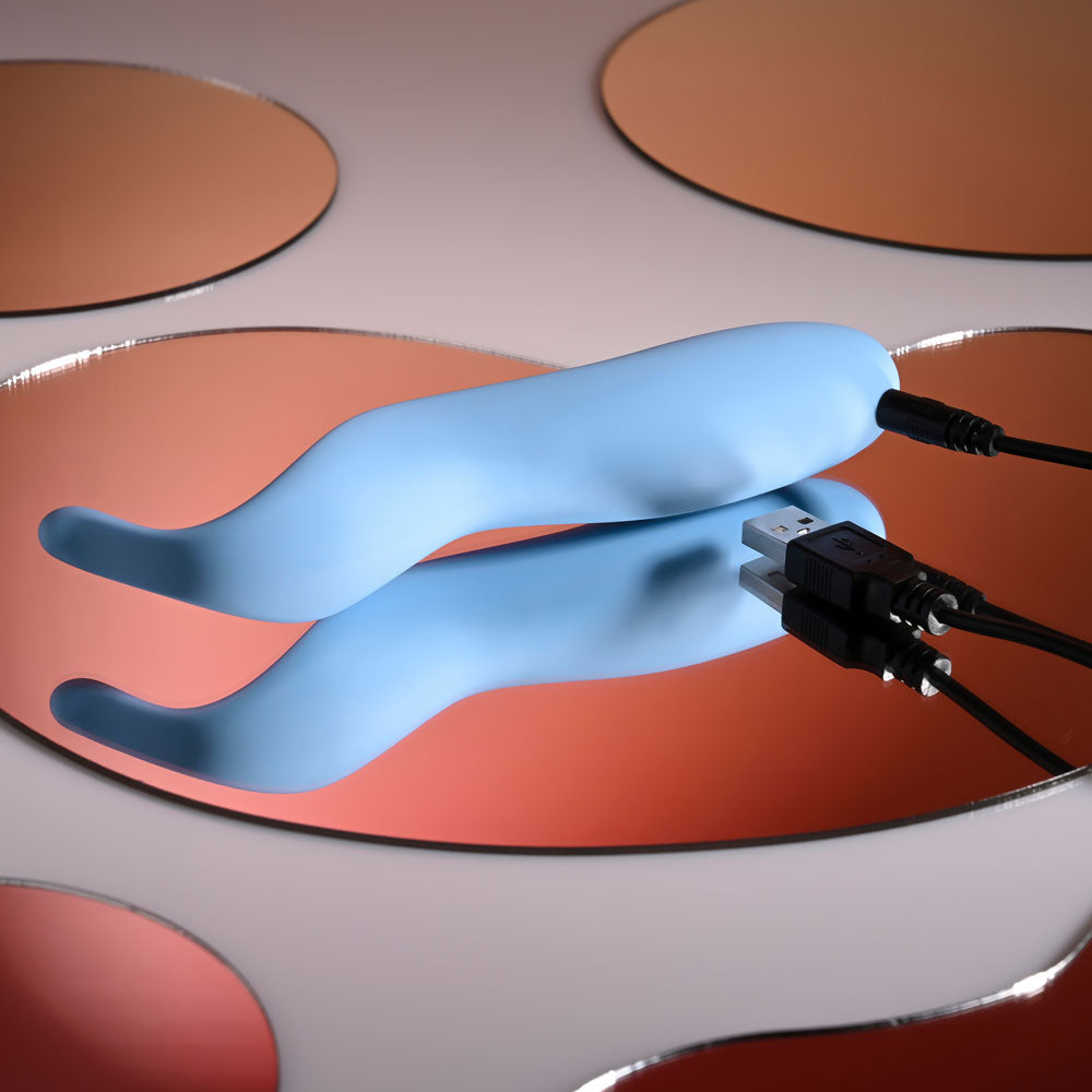 Selopa TENDER TICKLER -  16.2 cm USB Rechargeable Pinpoint Stimulator charging on stylish reflective surface.