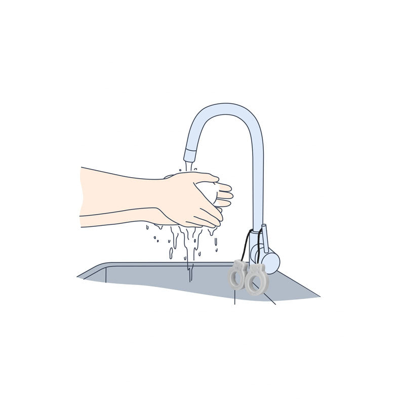 Washing hands with S-LINE Cuff Soap - Novelty Soap under a faucet, highlighting the unique handcuff design.