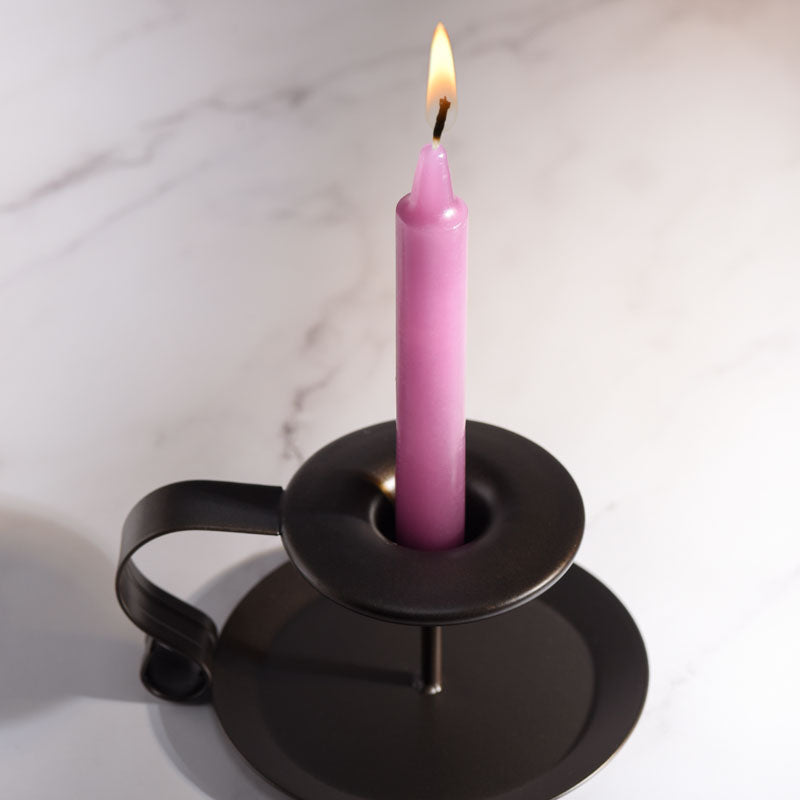 LaCire Drip Pillar Candles - Violet - Violet Drip Candles - Set of 3 in a candle holder with a flame.