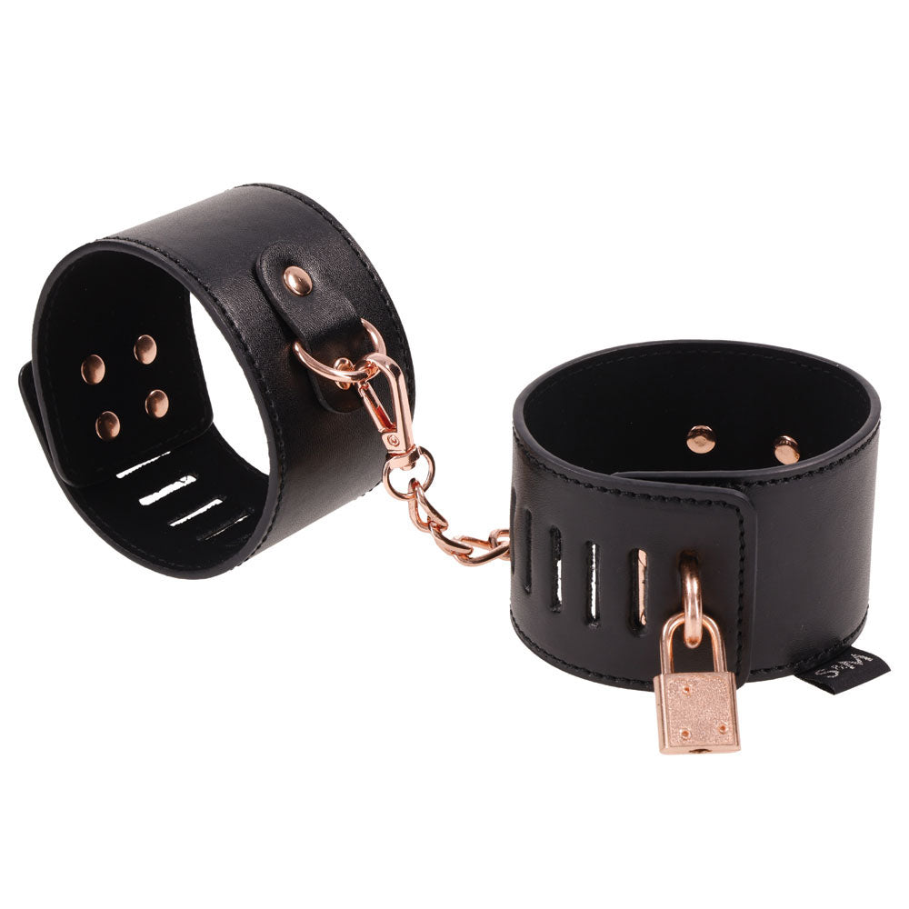 Sex & Mischief Brat Locking Cuffs - /Rose Gold Hand Cuffs in sleek black vegan leather with rose gold accents.