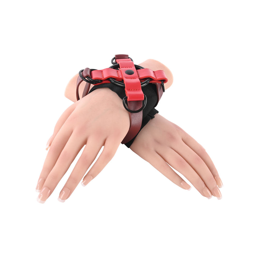 S&M Exs & Ohs Cross Cuffs - /Black Restraints featuring adjustable straps for comfortable wrist binding.