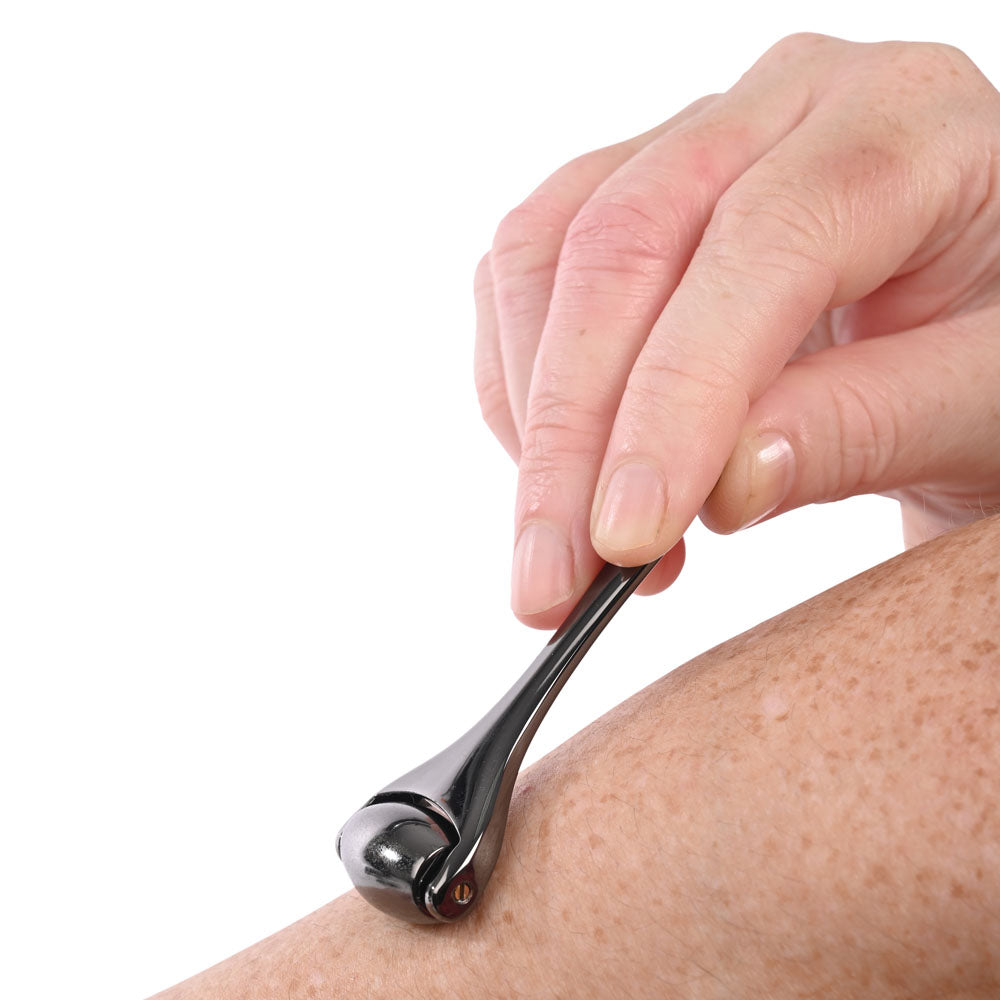 S&M Exs & Ohs Temperature Play Sensory Roller - Gunmetal Roller gliding over skin for temperature play.