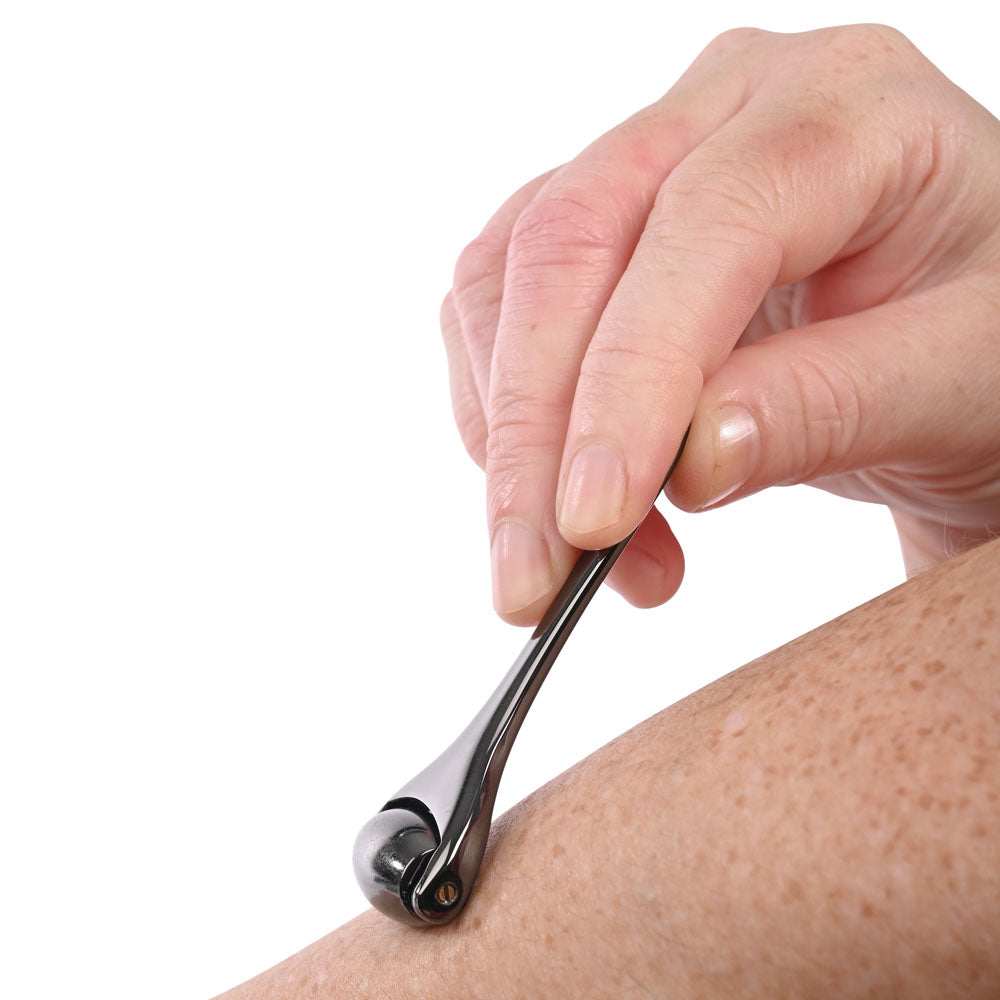 S&M Exs & Ohs Temperature Play Sensory Roller - Gunmetal Roller being used on skin for temperature play.
