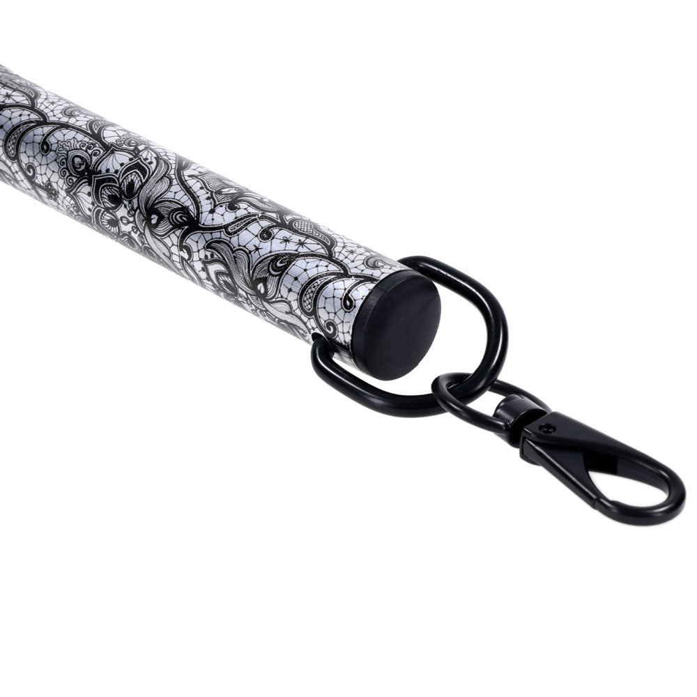 Sex & Mischief Lace Spreader Bar -  Restraint Bar featuring intricate lace design and sleek black clasps.