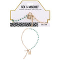 Sex & Mischief Indica Crystal Day Collar - Gold/Emerald Lockable Collar showcasing green gems and a gold chain.