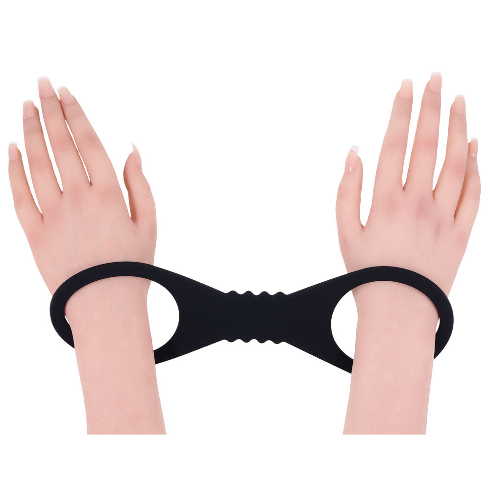 Sex & Mischief Shadow Large Silicone Cuffs - Large Restraints securing wrists in smooth, dark silicone for intimate play.