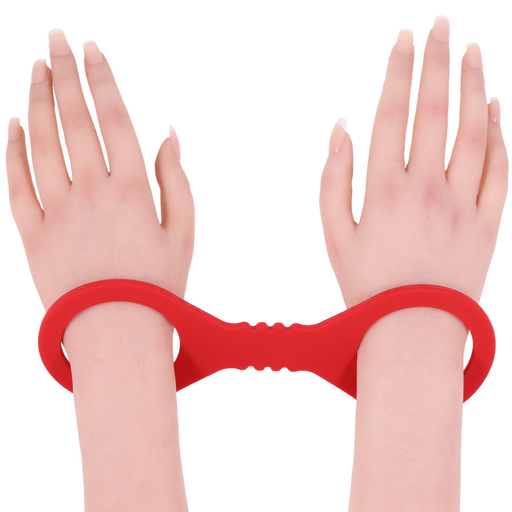 Sex & Mischief Amor Small Silicone Cuffs -  Small Restraints on wrists in smooth red silicone design.