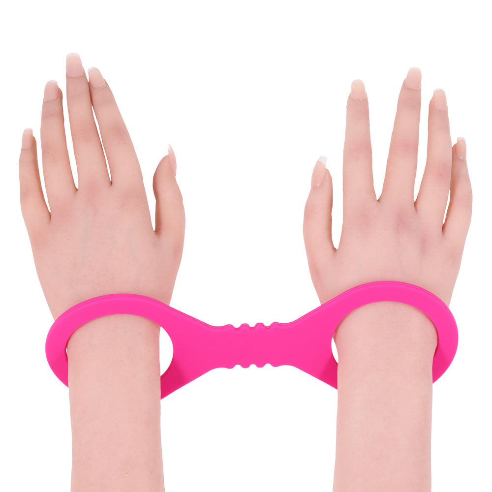 Sex & Mischief Small Hot  Silicone Cuffs - Hot  Small Restraints securely holding wrists together in playful hot pink.
