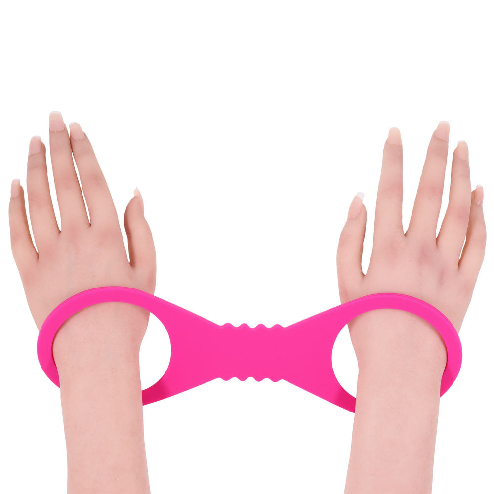 Sex & Mischief Large Hot  Silicone Cuffs - Hot  Large Restraints showcased on hands, highlighting the playful design.