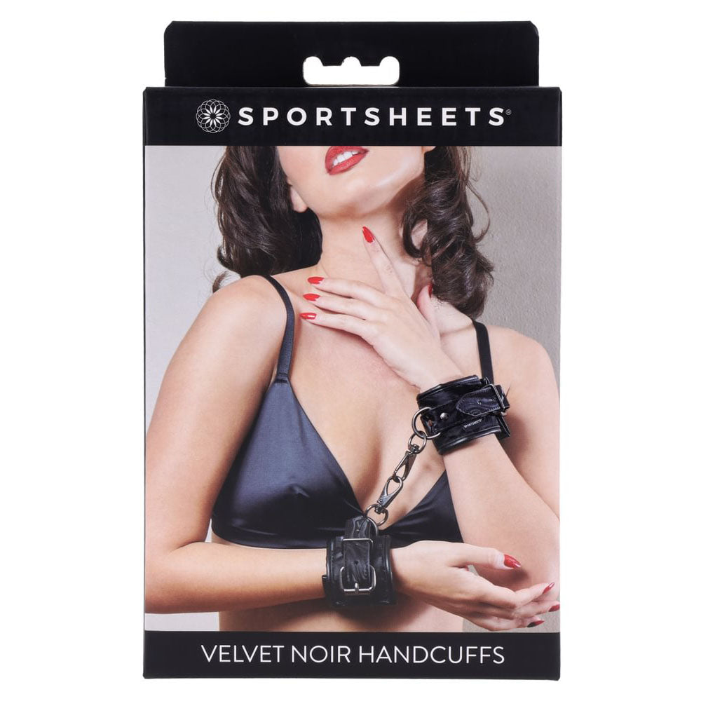 SPORTSHEETS Velvet Noir Handcuffs package featuring a model in a black bra, showcasing stylish bondage accessories.