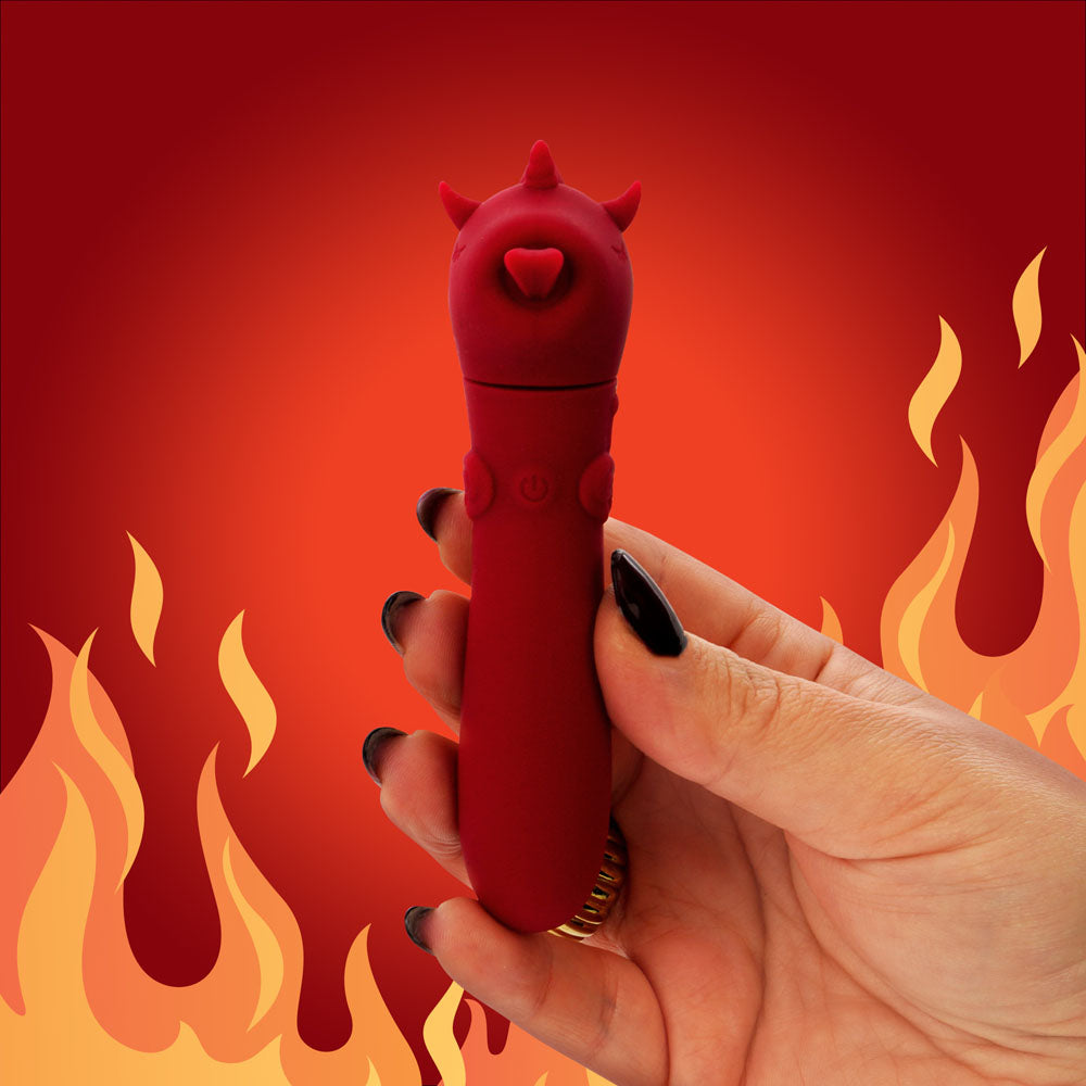 Unihorn - USB Bullet - Blaze Diablo -  USB Rechargeable Vibrating Bullet held in hand against a fiery background.