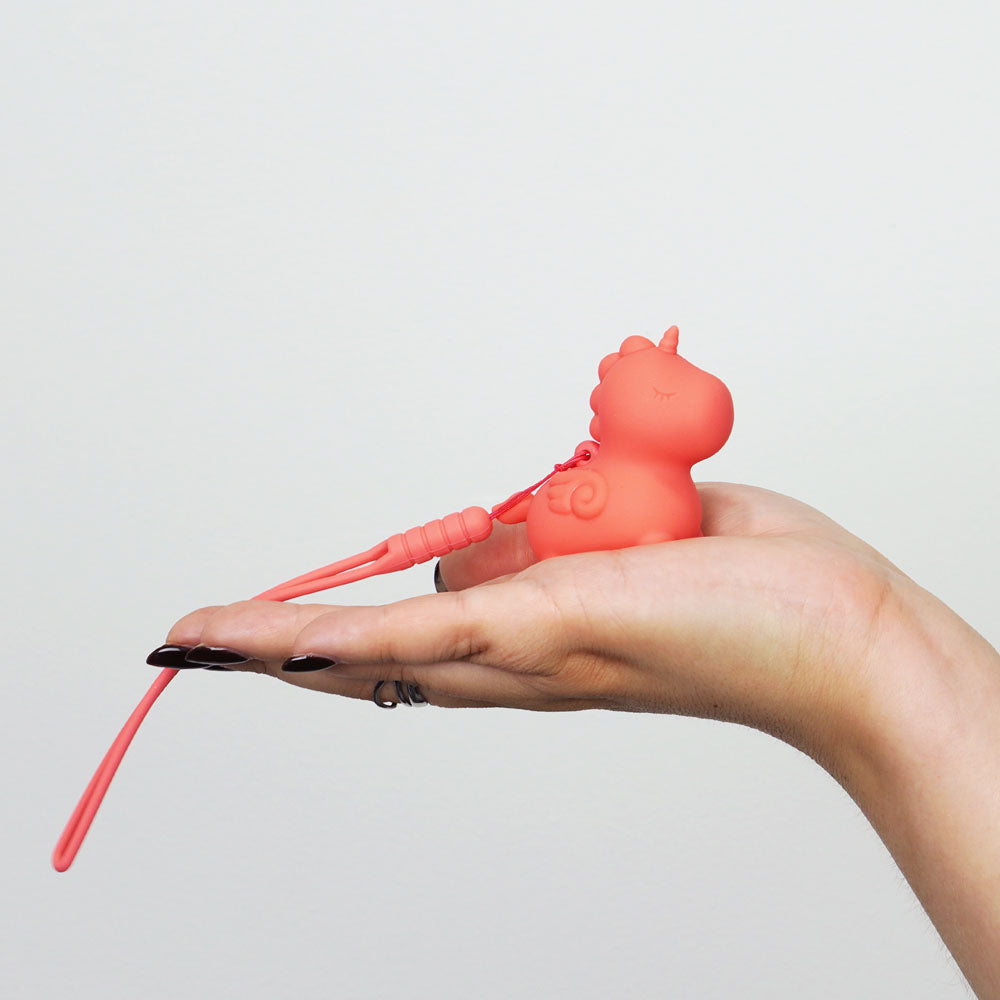 Unihorn Mini - Peachy Pony - Peach USB Rechargeable Stimulator held in hand, showcasing its cute design and compact size.