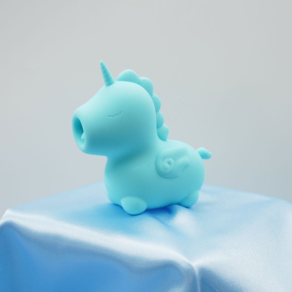 Unihorn - Mount'n Peak - Teal USB Rechargeable Flicking Stimulator displayed on a silky blue cloth.