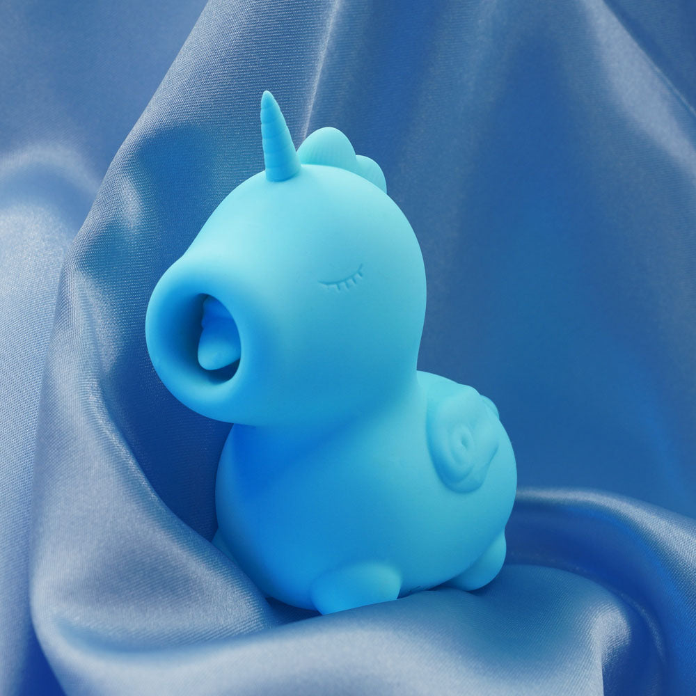Unihorn - Mount'n Peak - Teal USB Rechargeable Flicking Stimulator on silky fabric, perfect for intimate essentials.