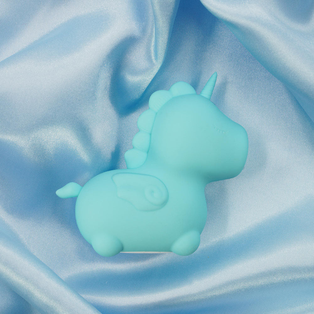 Unihorn - Mount'n Peak - Teal USB Rechargeable Flicking Stimulator on satin fabric background.