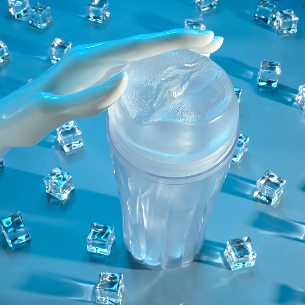 Zero Tolerance THE CHOICE - 21 cm Vagina Stroker surrounded by ice cubes, highlighting its transparent design and hand placement.
