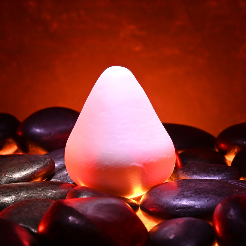 Zero Tolerance FUJI -  Mini Stroker Egg on smooth stones with warm lighting, ideal for intimate essentials for her.