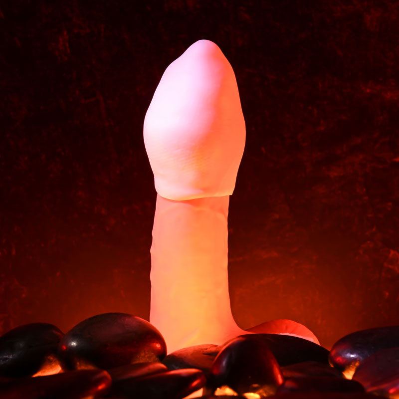 Zero Tolerance FUJI -  Mini Stroker Egg on smooth black stones with soft glowing lighting.