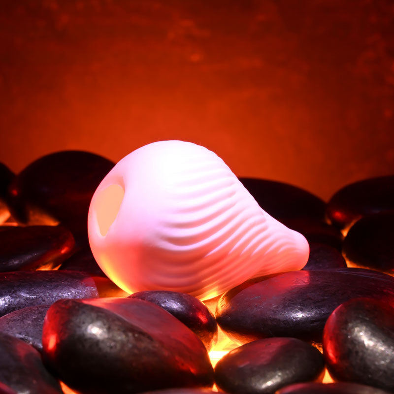 Zero Tolerance KILAUEA - Mini Stroker Egg on black stones, designed for ultimate pleasure and intimacy.