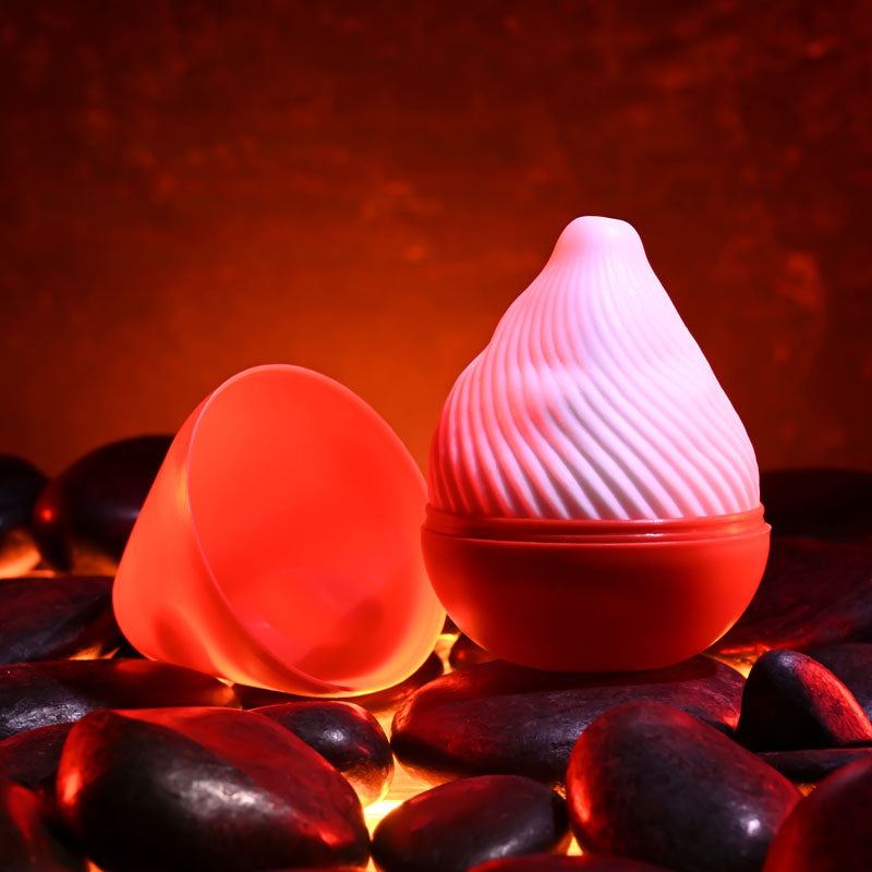 Zero Tolerance KILAUEA - Mini Stroker Egg on glowing stones, designed for ultimate pleasure and intimate essentials.