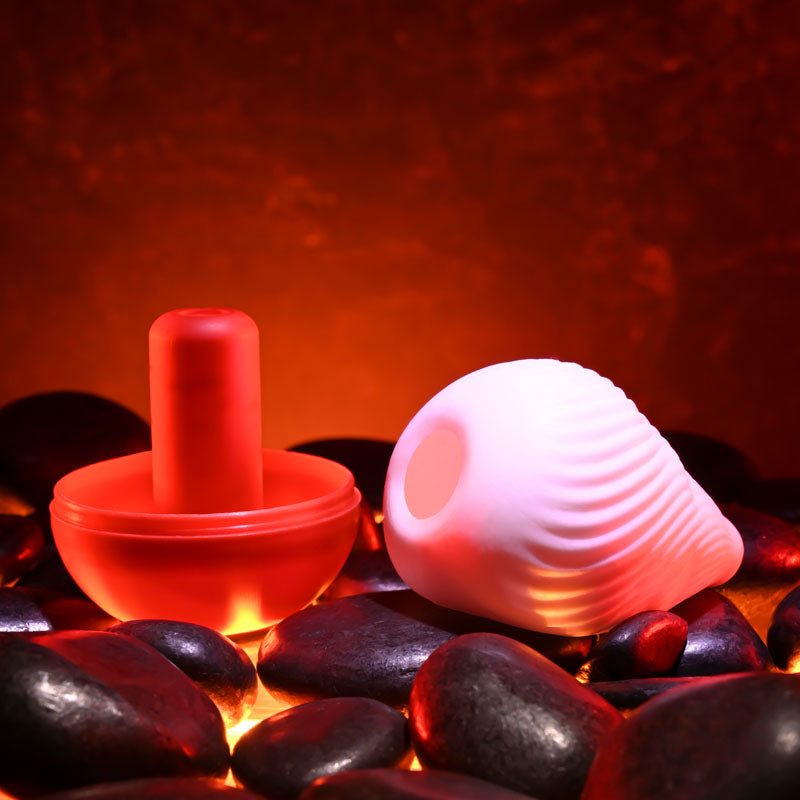 Zero Tolerance KILAUEA - Mini Stroker Egg and red male masturbation toy on heated stones.