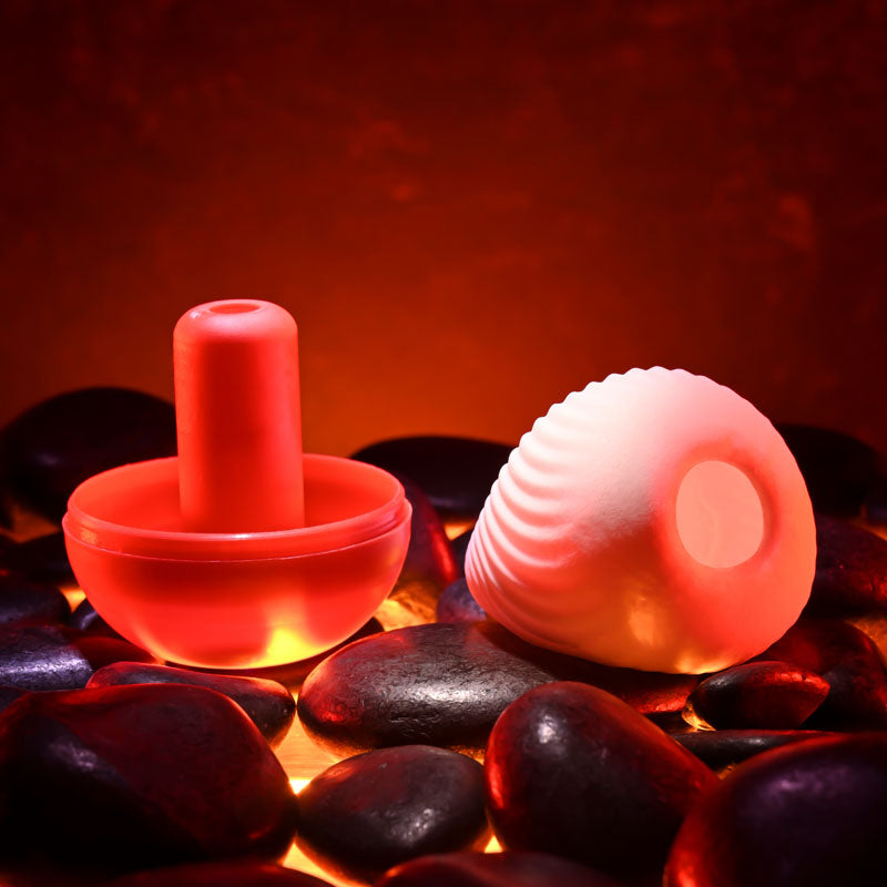 Zero Tolerance VESUVIUS - Mini Stroker Egg on heated stones, perfect for intimate essentials, and enhancing pleasure.
