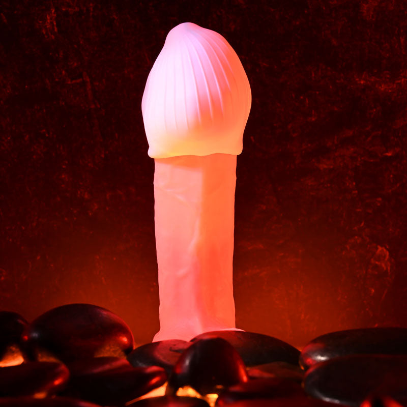 Zero Tolerance KRAKATOA -  Mini Stroker Egg on a bed of stones, glowing warmly for intimate pleasure.