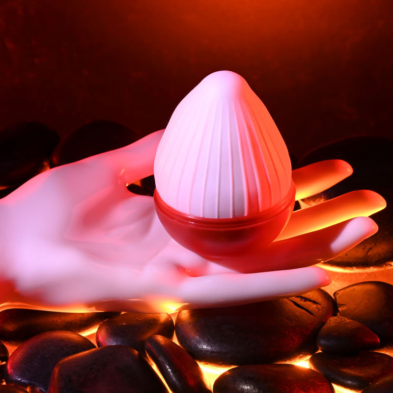 Zero Tolerance KRAKATOA - Mini Stroker Egg resting in a hand, designed for ultimate pleasure and comfort.