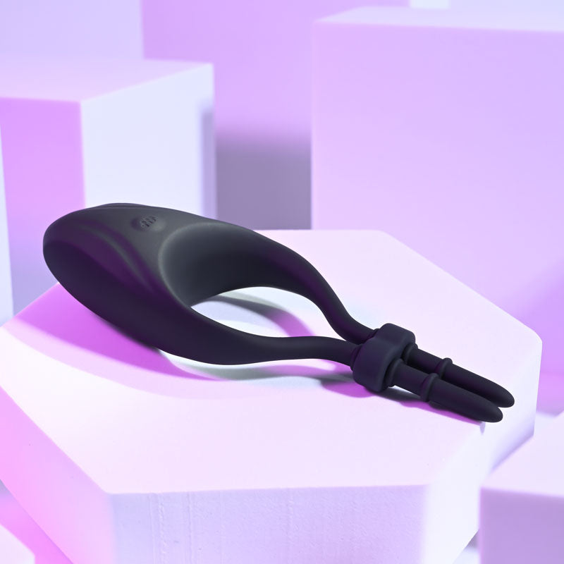 Zero Tolerance PERFECT FIT -  USB Rechargeable Vibrating Lasso Cock Ring against a soft purple background.