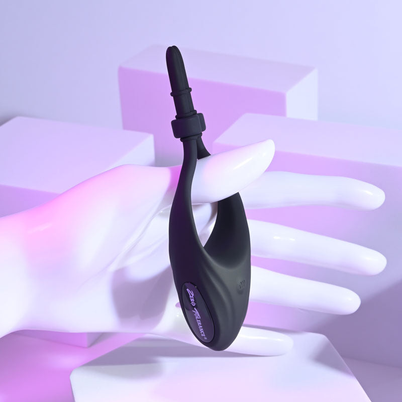 Zero Tolerance PERFECT FIT -  USB Rechargeable Vibrating Lasso Cock Ring held in hand against a colorful background.