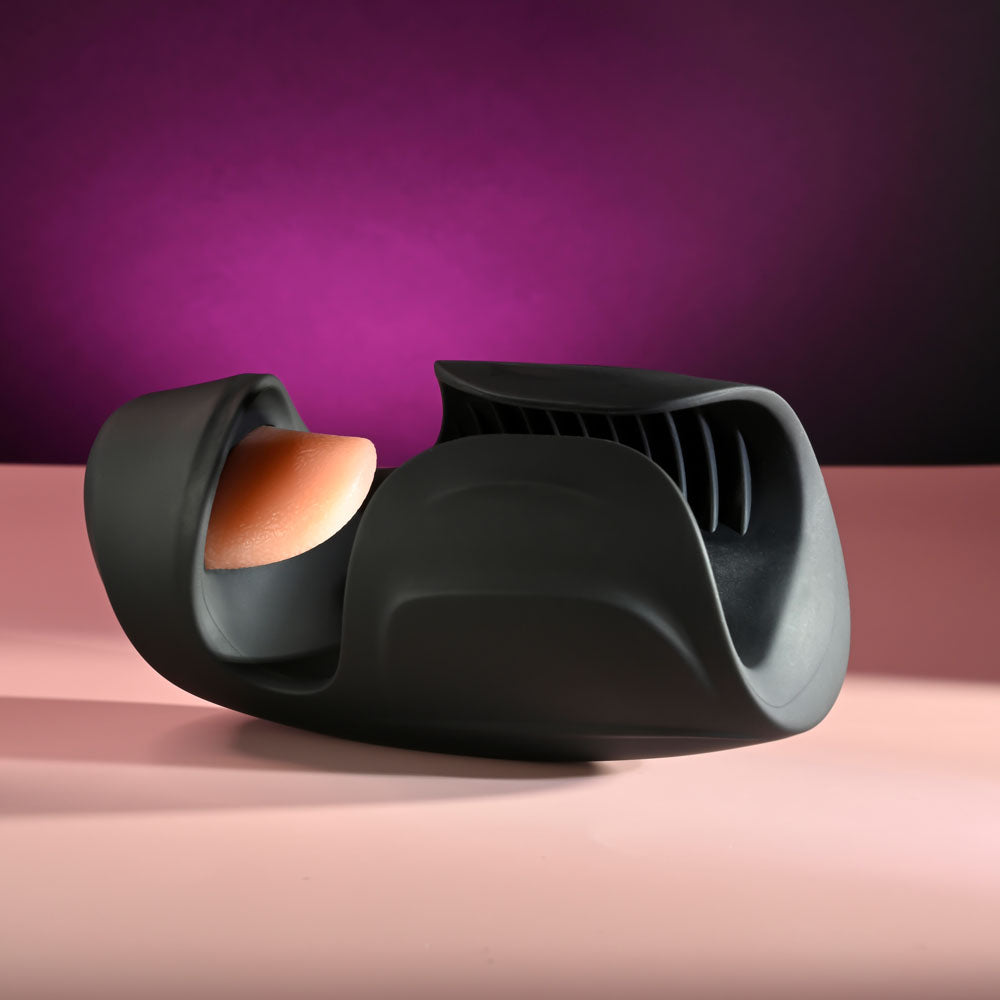 Zero Tolerance LICK THE TIP -  USB Rechargeable Vibrating & Flicking Masturbator on a pink background.