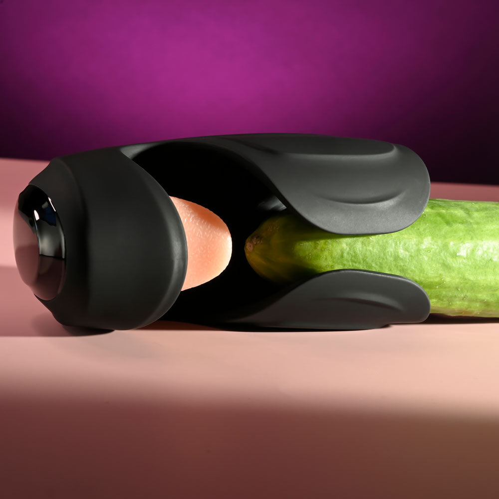 Zero Tolerance LICK THE TIP -  USB Rechargeable Vibrating & Flicking Masturbator displayed with a cucumber for illustrative purposes.